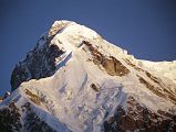 10 Rakhiot Peak East Face Close Up From Tarashing At Sunrise Rakhiot Peak South Face to the left and East Face to the right shine in the early morning sun from Tarashing. Rakhiot Peak (7070m) was first climbed on July 16, 1932 by Peter Aschenbrenner and Herbert Kunigk while attempting Nanga Parbat. Hermann Buhl climbed the summit needle of Rakhiot Peak on June 21, 1953 on the way to the first ascent of Nanga Parbat.